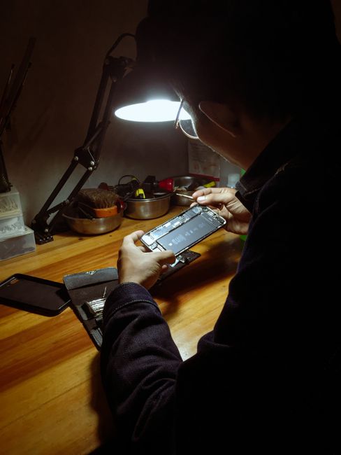 Technician checking smartphone schedule — illustrating job scheduling and team notifications for Georgia small businesses